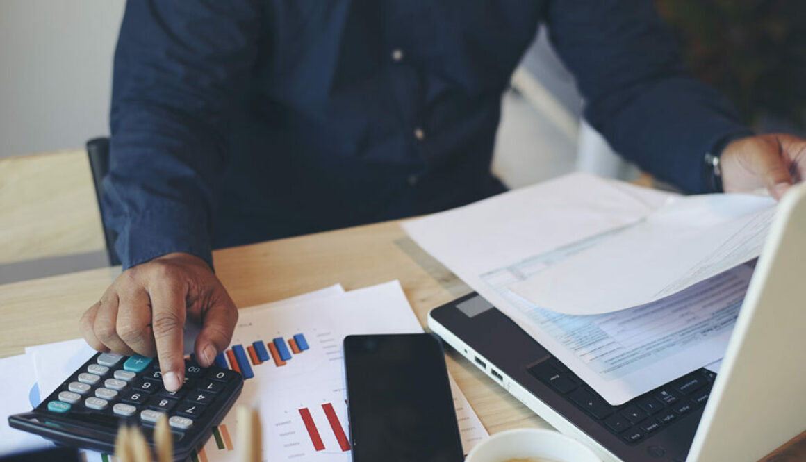 Man Completing Taxes and Figuring His Tax Deductible Donations