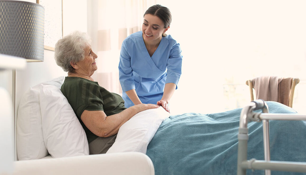 A Care Worker Adjusting The Bed Sheets For An Elderly Hospice Patient Difference Between Inpatient Hospice vs. Outpatient Hospice.