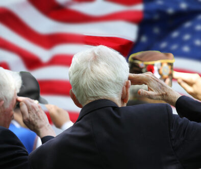 Two Elderly Veterans Saluting an American Flag Do Veterans Qualify for Hospice Care