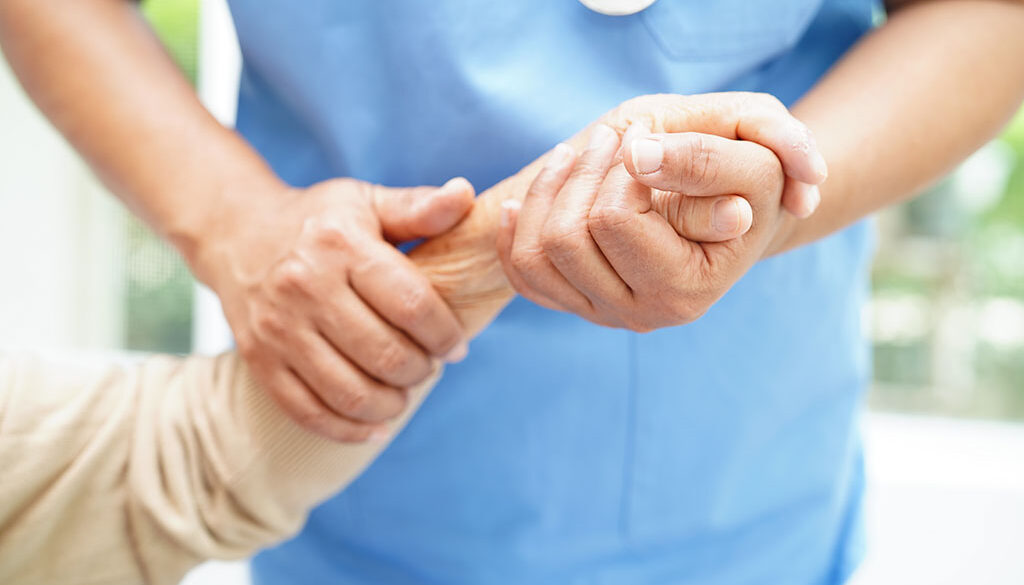 Doctor Holding The Hand of an Elderly Hospice Patient What You Don't Know About Hospice Care