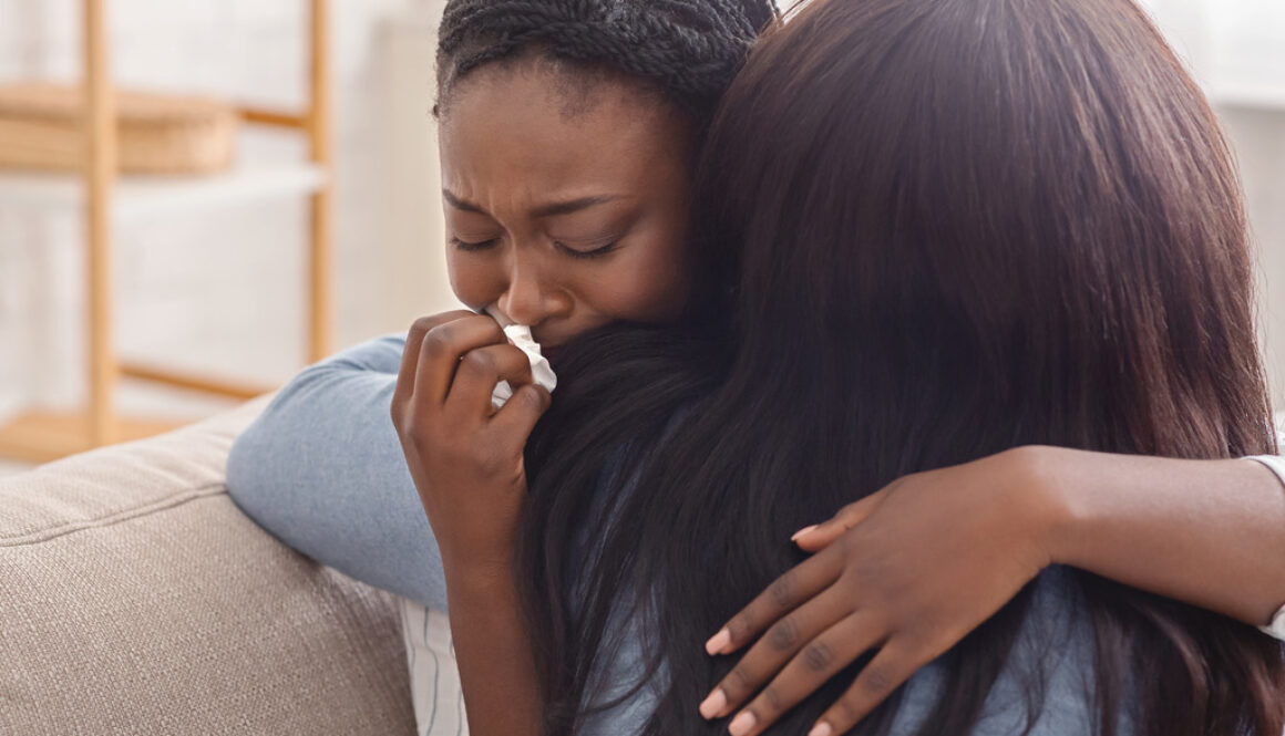 A Crying Woman Being Hugged By Her Friend. Does In-Home Hospice Help After Death