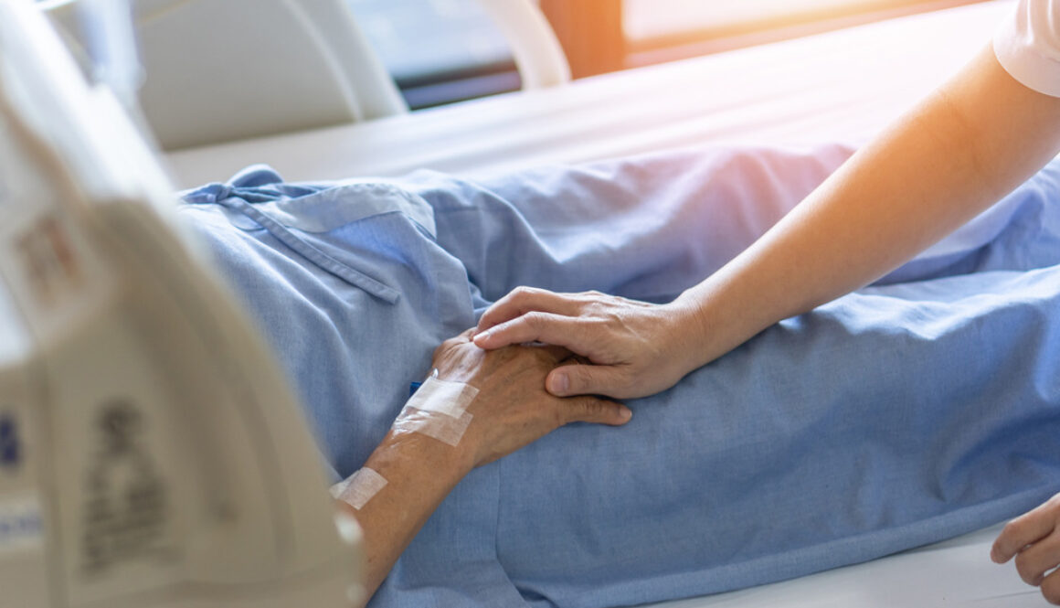 Closeup of a Hospice Patient Holding Hands with a Loved One How Long is Someone Usually in Hospice