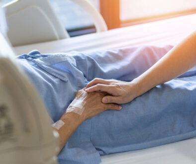 Closeup of a Hospice Patient Holding Hands with a Loved One How Long is Someone Usually in Hospice