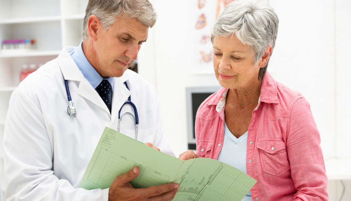 A Doctor Showing a Senior Female Patient a Green Medical Form Does Medicare Cover Home Health Care