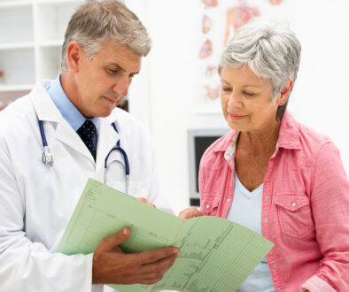 A Doctor Showing a Senior Female Patient a Green Medical Form Does Medicare Cover Home Health Care