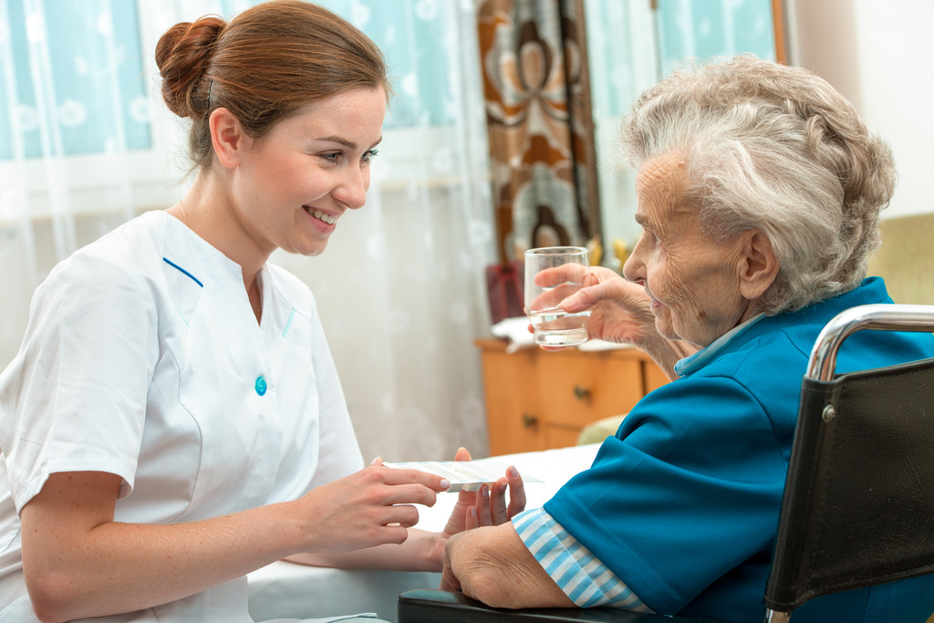 A Nurse Gives a Senior Medication