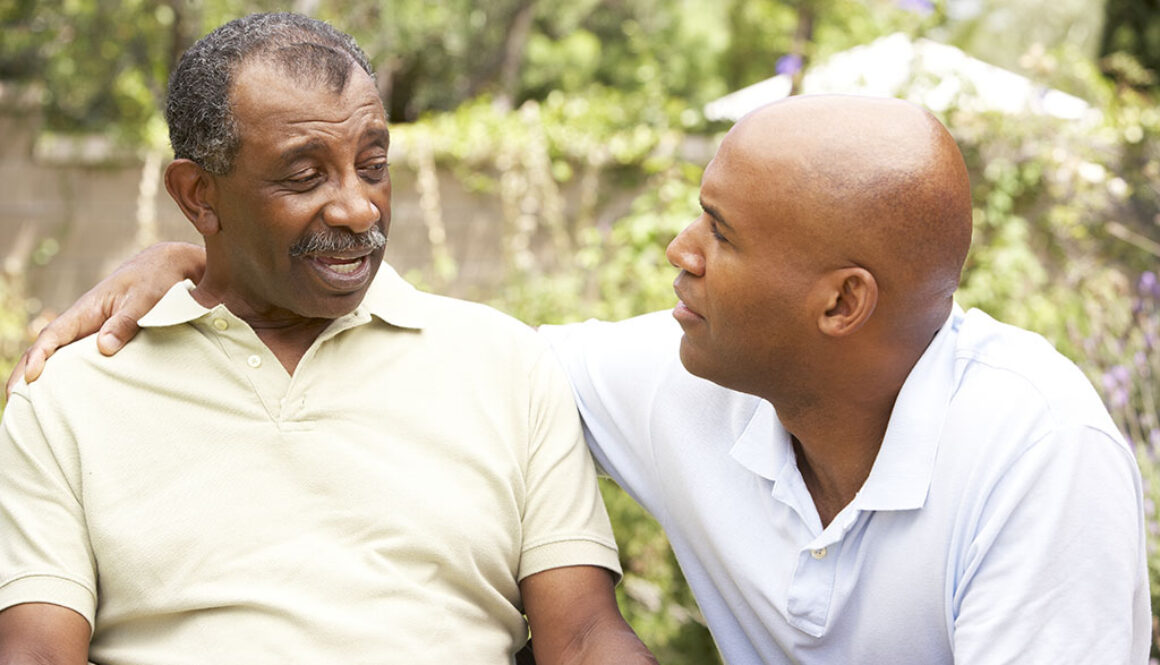 An African American Man With His Arm Around His Senior Dad’s Shoulder Having Serious End-Of-Life Conversations