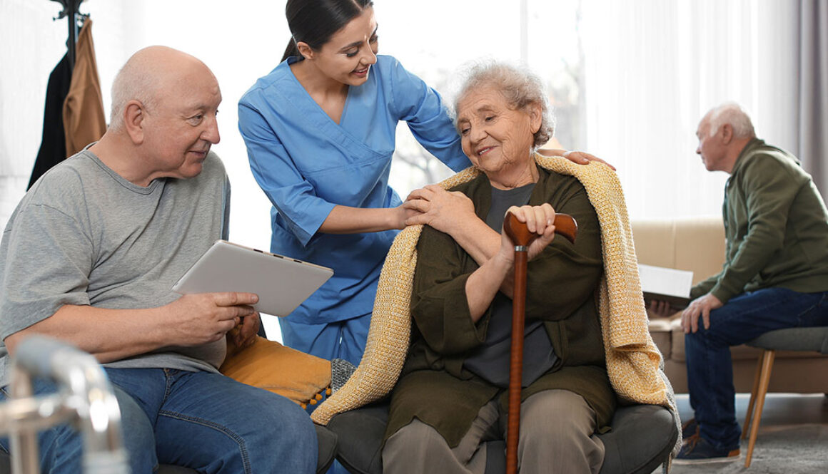 A Hospice Caregiver Wrapping a Blanket Around a Senior Woman in Hospice Care Non-profit vs For-Profit Hospice