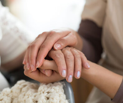 Close Up Of A Hospice Nurse Holding A Patient's Hand Providing Emotional Support For Hospice Patients