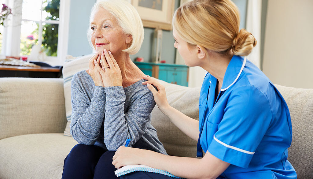 A Counselor Comforting A Senior Woman Sitting Beside Her Working Through Grief
